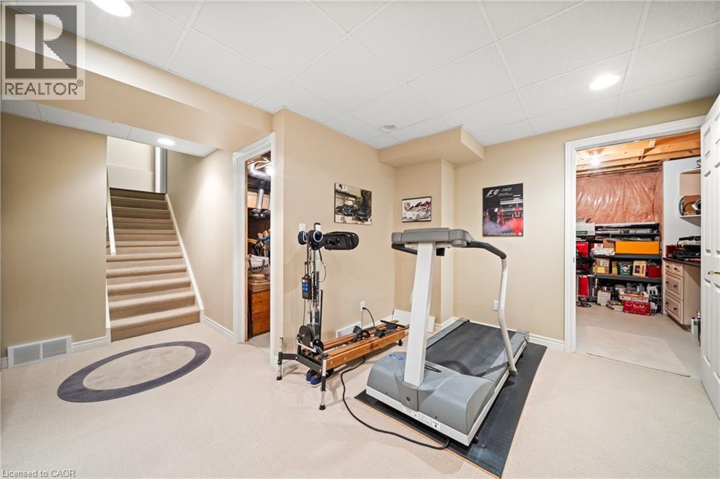 Workout room featuring a drop ceiling, light colored carpet, and recessed lighting - 4165 Stonebridge Crescent, Burlington, ON - Indoor Photo Showing Gym Room