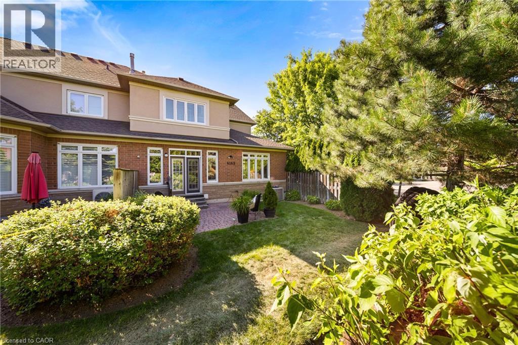Back of house featuring stucco siding and brick siding - 4165 Stonebridge Crescent, Burlington, ON - Outdoor