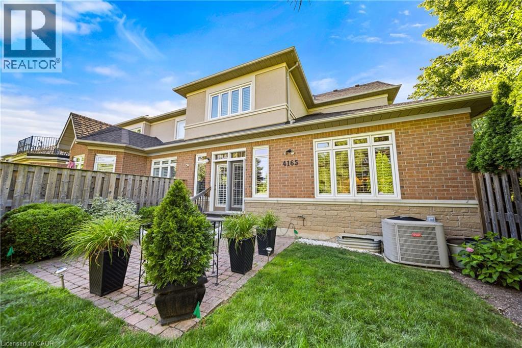 Back of house featuring a patio, brick siding, and stucco siding - 4165 Stonebridge Crescent, Burlington, ON - Outdoor