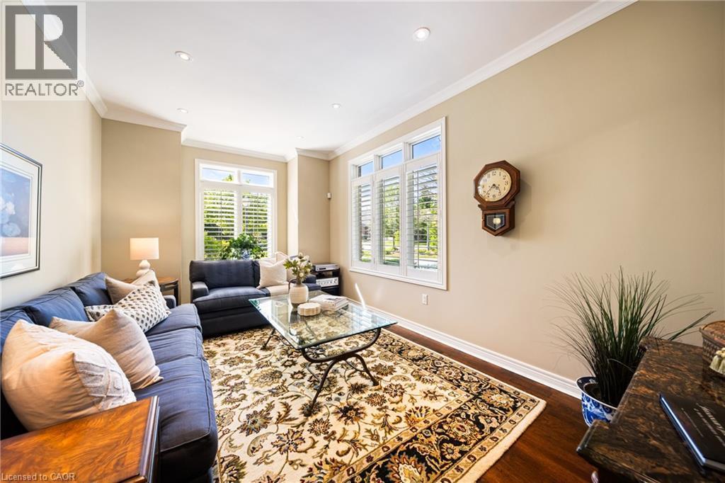 Living area with dark wood-style flooring, crown molding, and recessed lighting - 4165 Stonebridge Crescent, Burlington, ON - Indoor Photo Showing Living Room