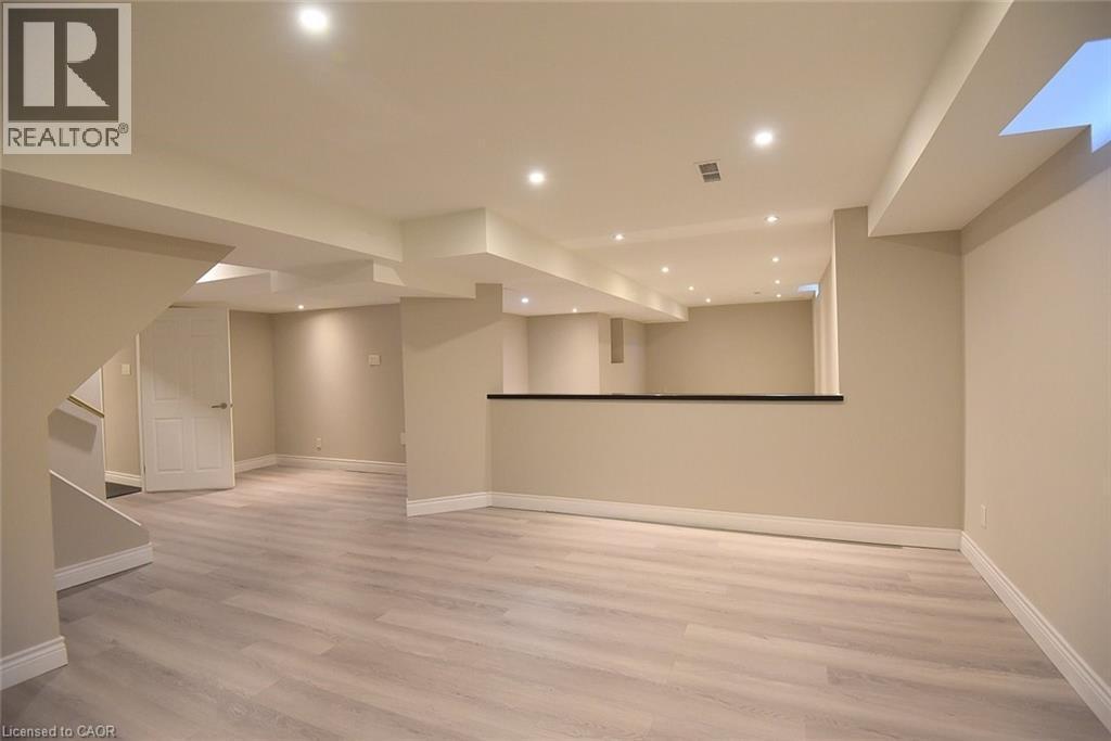Finished below grade area featuring light wood-style flooring and recessed lighting - 5109 Blue Spruce Avenue, Burlington, ON - Indoor Photo Showing Other Room