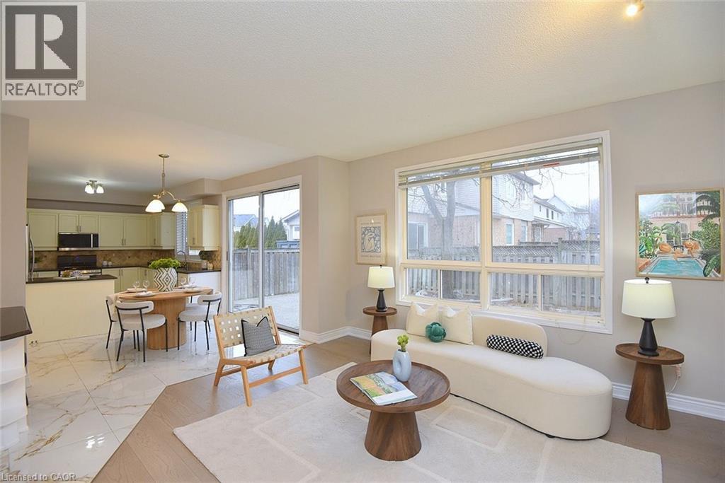 Sitting room featuring light marble finish floors and a chandelier - 5109 Blue Spruce Avenue, Burlington, ON - Indoor Photo Showing Living Room