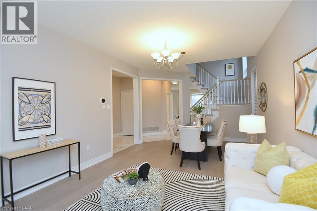 Living room with a chandelier, wood finished floors, and stairs - 5109 Blue Spruce Avenue, Burlington, ON - Indoor