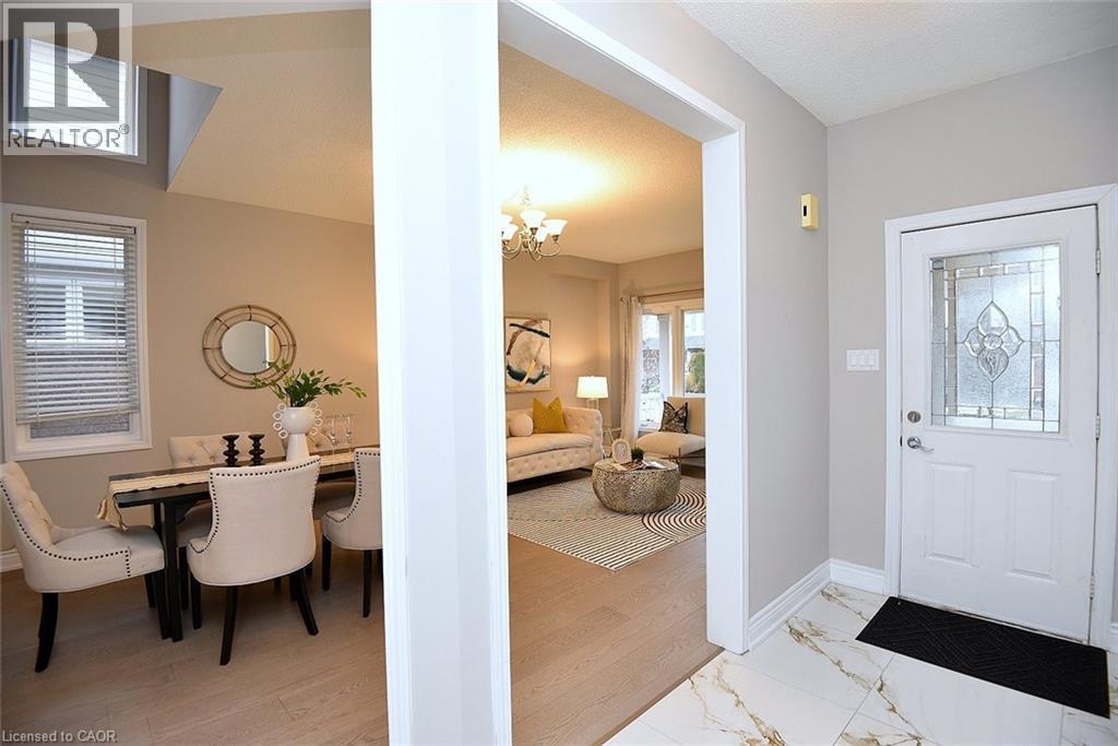 Entrance foyer featuring a chandelier and light marble finish floors - 5109 Blue Spruce Avenue, Burlington, ON - Indoor Photo Showing Other Room