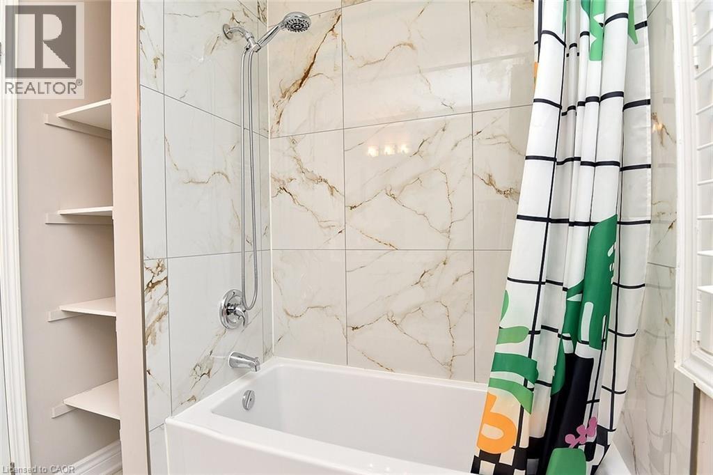 Bathroom featuring shower / bathtub combination with curtain - 5109 Blue Spruce Avenue, Burlington, ON - Indoor Photo Showing Bathroom