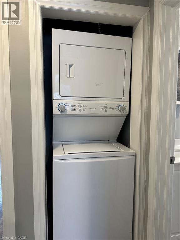 Washroom featuring stacked washing machine and dryer - 80 Glen Road Unit# Upper, Kitchener, ON - Indoor Photo Showing Laundry Room