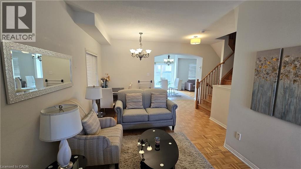 Living area with a chandelier, stairway, and arched walkways - 3688 Emery Drive, Mississauga, ON - Indoor