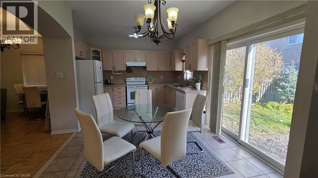 Dining space with a chandelier and light tile patterned floors - 3688 Emery Drive, Mississauga, ON - Indoor Photo Showing Dining Room