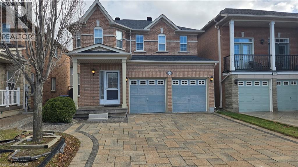 View of front of property featuring decorative driveway, an attached garage, and roof with shingles - 3688 Emery Drive, Mississauga, ON - Outdoor With Facade