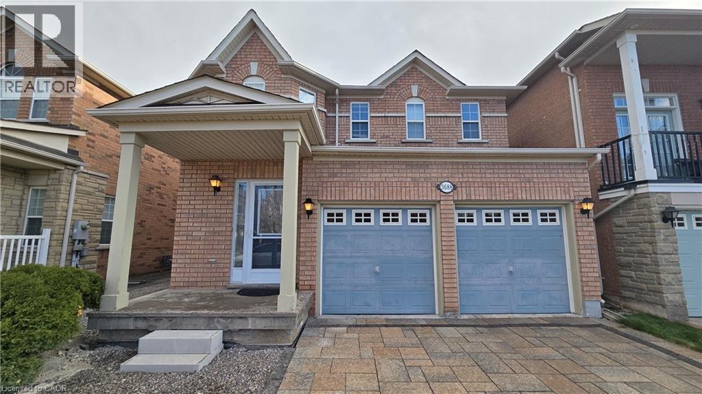 Traditional-style home with driveway, a garage, and brick siding - 3688 Emery Drive, Mississauga, ON - Outdoor With Facade
