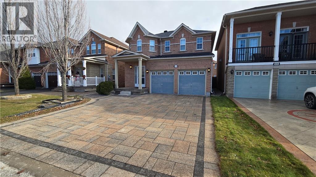 View of front facade with driveway, brick siding, and an attached garage - 3688 Emery Drive, Mississauga, ON - Outdoor With Facade