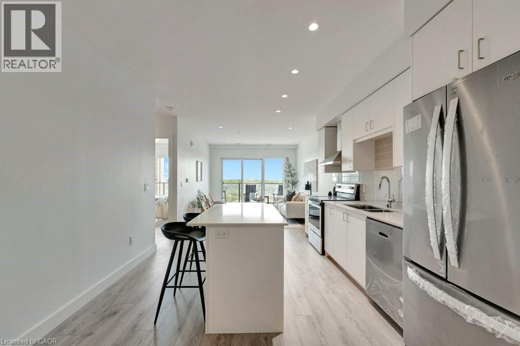 Kitchen featuring appliances with stainless steel finishes, a kitchen island, white cabinets, modern cabinets, and recessed lighting - 15 Glebe Street Unit# 1511, Cambridge, ON - Indoor Photo Showing Kitchen With Upgraded Kitchen