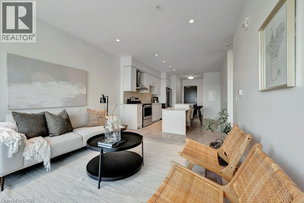 Living room with light wood finished floors and recessed lighting - 15 Glebe Street Unit# 1511, Cambridge, ON - Indoor Photo Showing Living Room