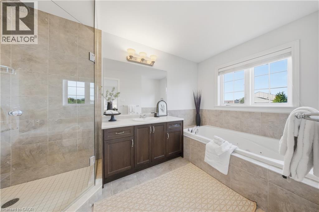 Full bathroom with vanity, a whirlpool tub, a stall shower, and light tile patterned floors - 8 Summerberry Way, Hamilton, ON - Indoor Photo Showing Bathroom