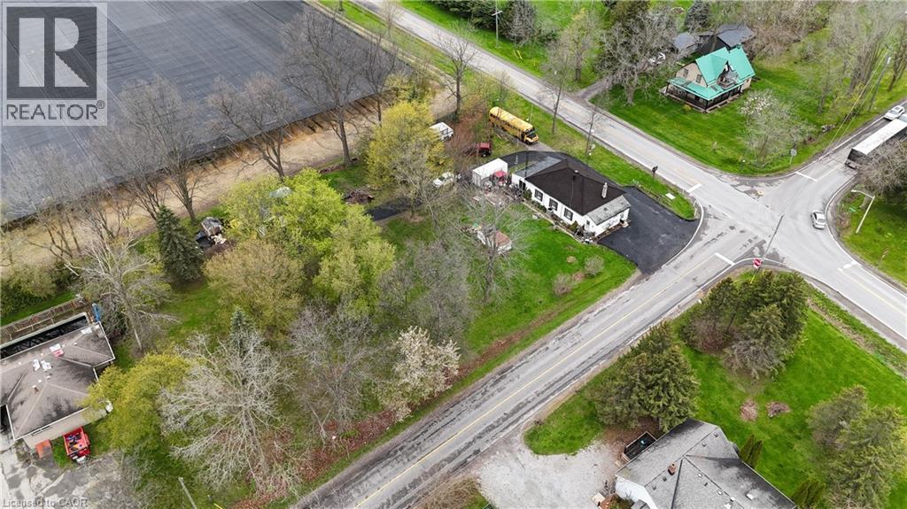 Property with a white exterior and dark roof, positioned at a road intersection - 740 Hillcrest Road, Simcoe, ON - Outdoor With View