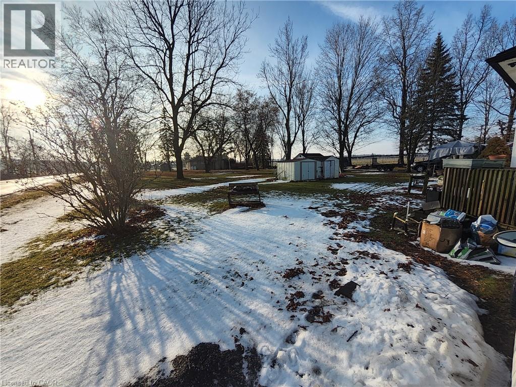 Yard layered in snow featuring a shed - 740 Hillcrest Road, Simcoe, ON - Outdoor