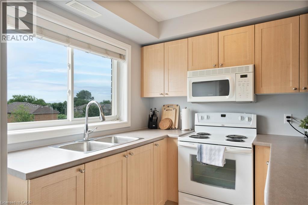 4450 Fairview Street Unit# 304, Burlington, ON - Indoor Photo Showing Kitchen With Double Sink