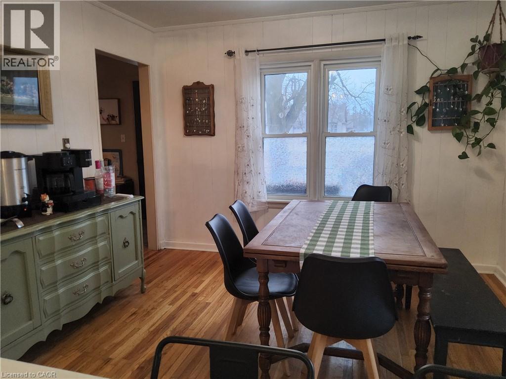 Dining area featuring light wood-style flooring and wood walls - 509 Queensway W, Simcoe, ON - Indoor Photo Showing Dining Room