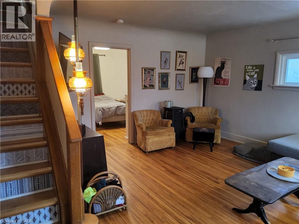 Living area featuring stairway and light wood-type flooring - 509 Queensway W, Simcoe, ON - Indoor