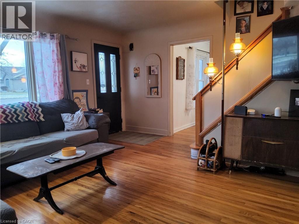 Living area with stairway, wood finished floors, and healthy amount of natural light - 509 Queensway W, Simcoe, ON - Indoor Photo Showing Living Room