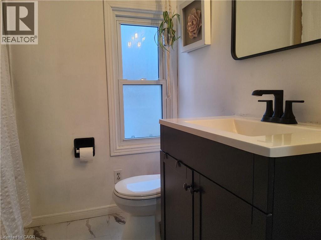 2nd floor Bathroom with vanity, marble look tile flooring, and healthy amount of natural light - 509 Queensway W, Simcoe, ON - Indoor Photo Showing Bathroom