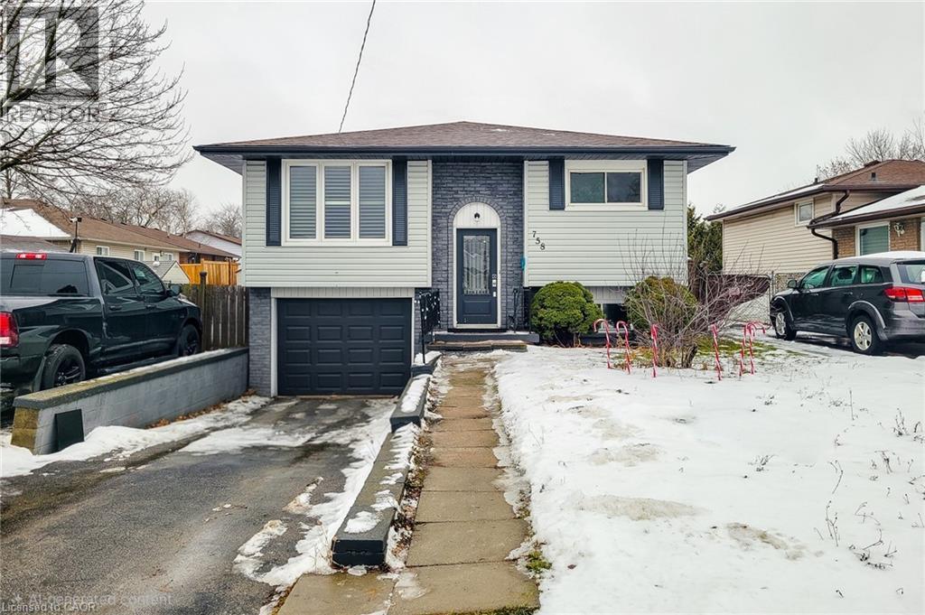Raised ranch with brick siding, a garage, and driveway - 758 Stone Church Road E, Hamilton, ON - Outdoor