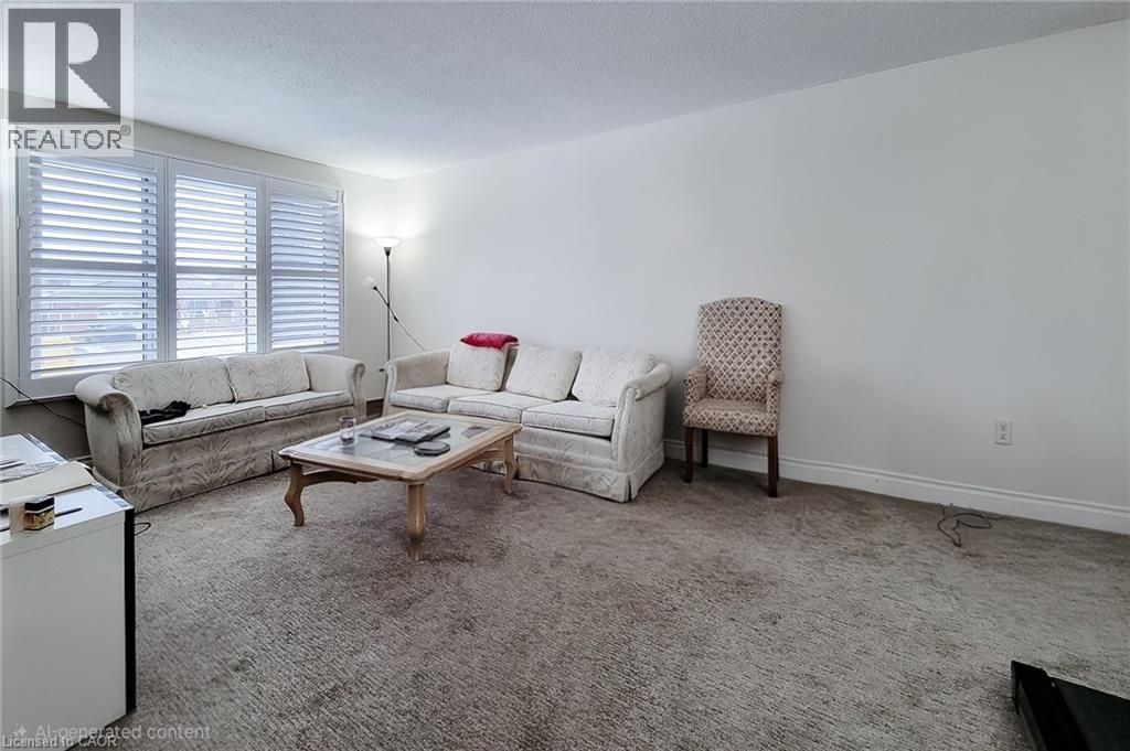 Carpeted living area with a textured ceiling and baseboards - 758 Stone Church Road E, Hamilton, ON - Indoor Photo Showing Living Room