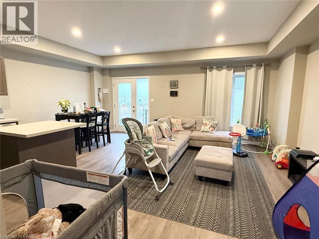 Living room with light wood-style flooring, french doors, recessed lighting, and healthy amount of natural light - 65 Old School Trail Unit# 36, Welland, ON - Indoor Photo Showing Living Room