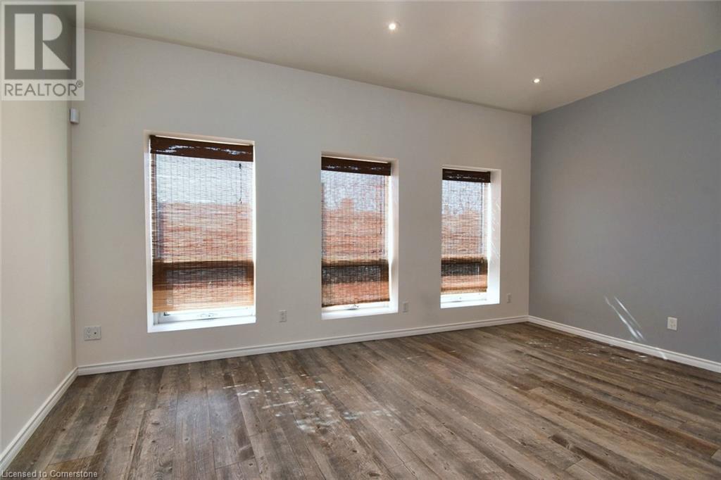 Spare room with baseboards and wood finished floors - 329 King Street E Unit# 3, Hamilton, ON - Indoor Photo Showing Other Room