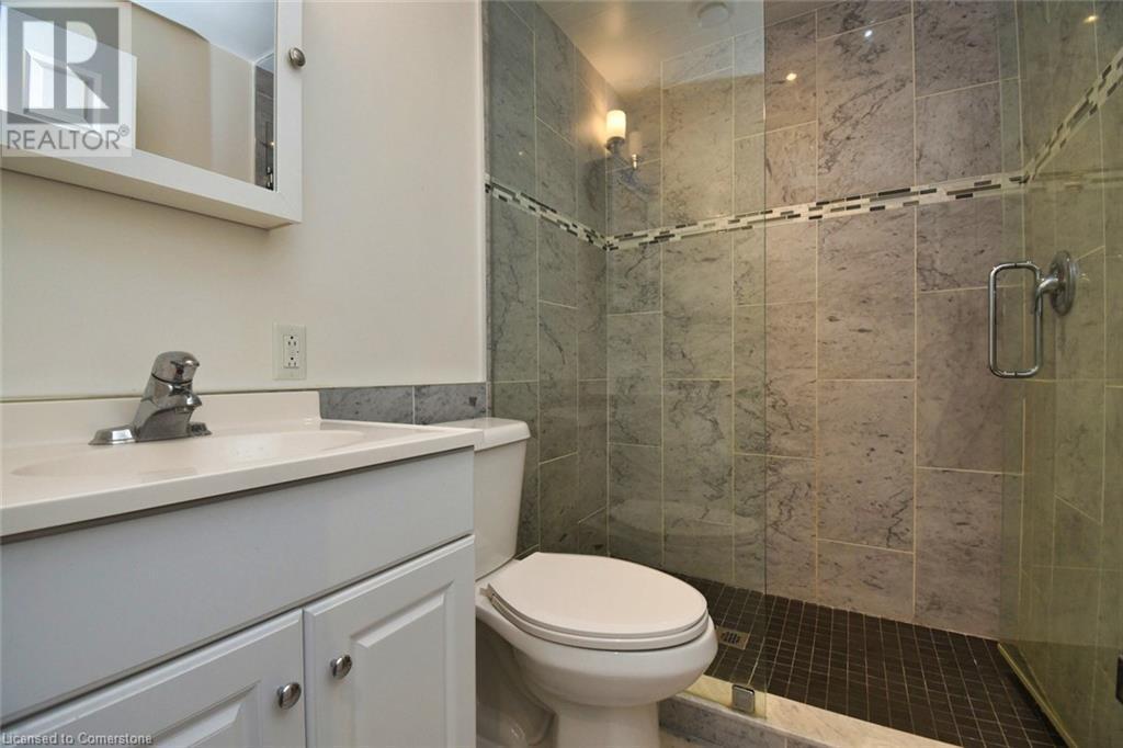 Bathroom featuring vanity, toilet, and a stall shower - 329 King Street E Unit# 3, Hamilton, ON - Indoor Photo Showing Bathroom
