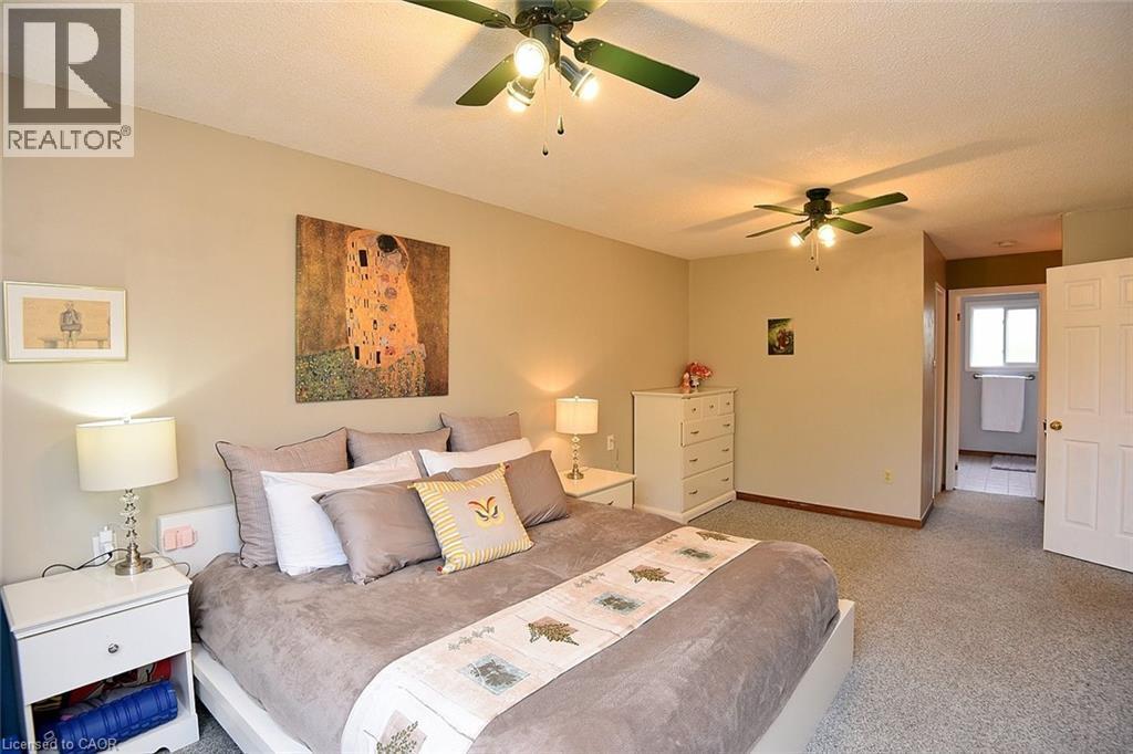 Bedroom with a ceiling fan, a textured ceiling, and carpet flooring - 43 Niska Drive, Waterdown, ON - Indoor Photo Showing Bedroom