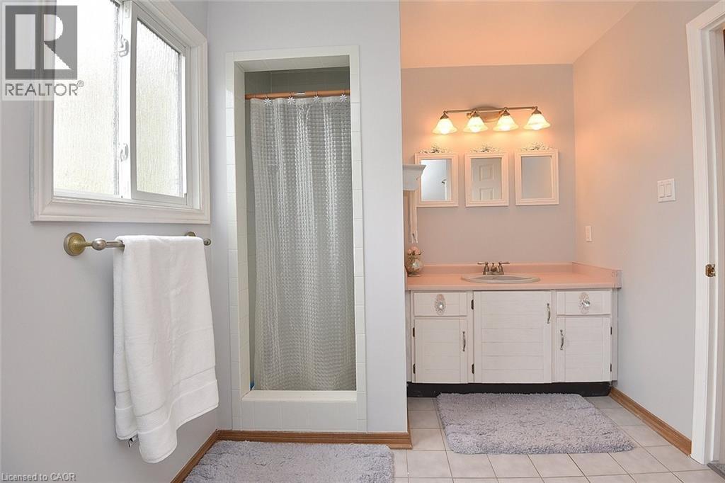 Bathroom featuring vanity, a shower stall, and light tile patterned floors - 43 Niska Drive, Waterdown, ON - Indoor Photo Showing Bathroom
