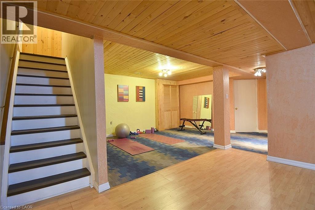 Finished basement with wooden ceiling, light wood finished floors, stairway, and a textured wall - 43 Niska Drive, Waterdown, ON - Indoor Photo Showing Other Room