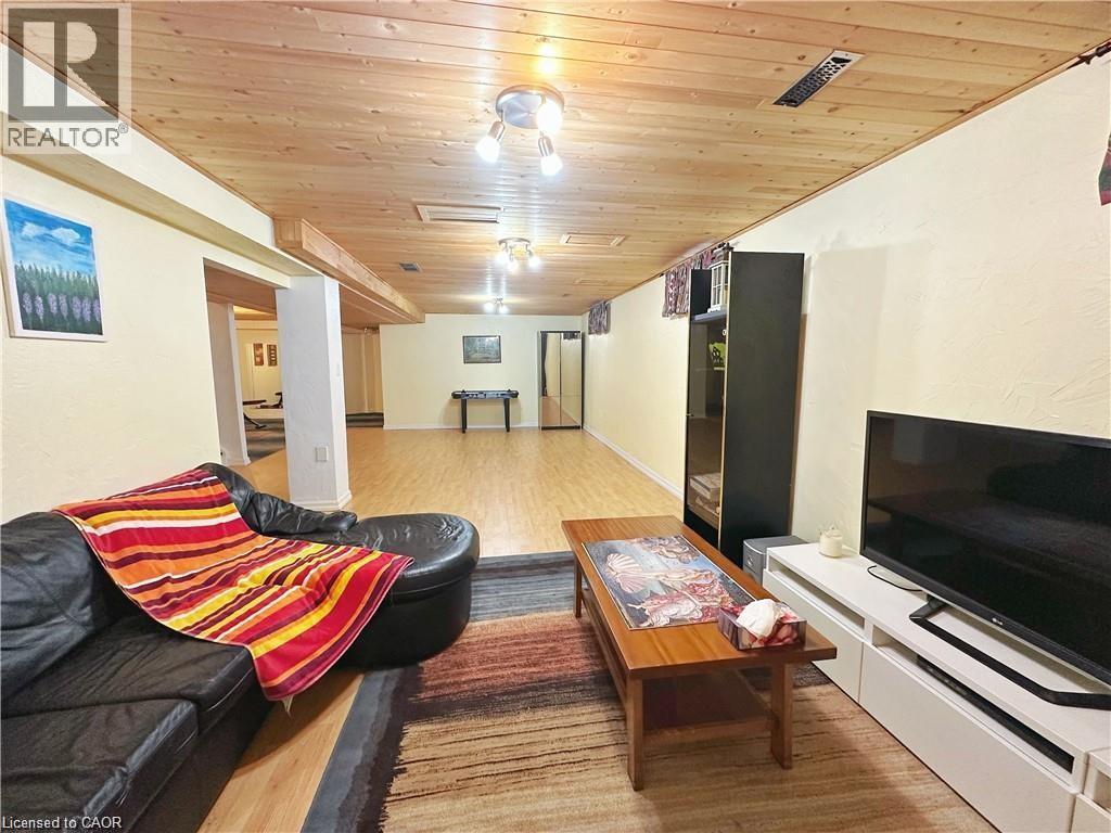 Living room with wooden ceiling and light wood-type flooring - 43 Niska Drive, Waterdown, ON - Indoor