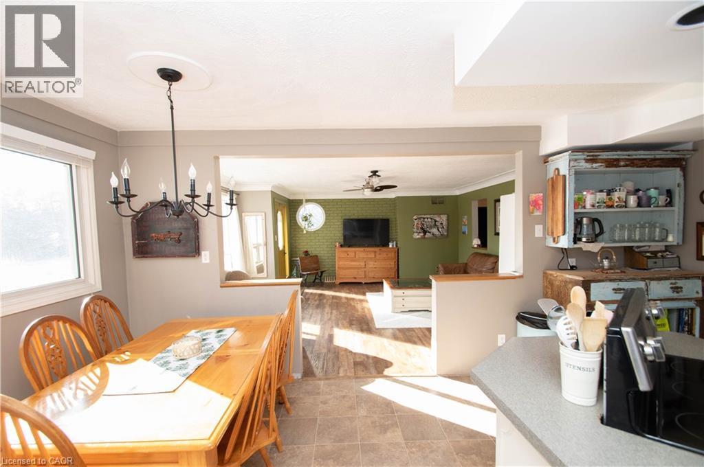 Dining room featuring a ceiling fan, ornamental molding, and a chandelier - 535 Mcdowell Road E, Simcoe, ON - Indoor Photo Showing Dining Room