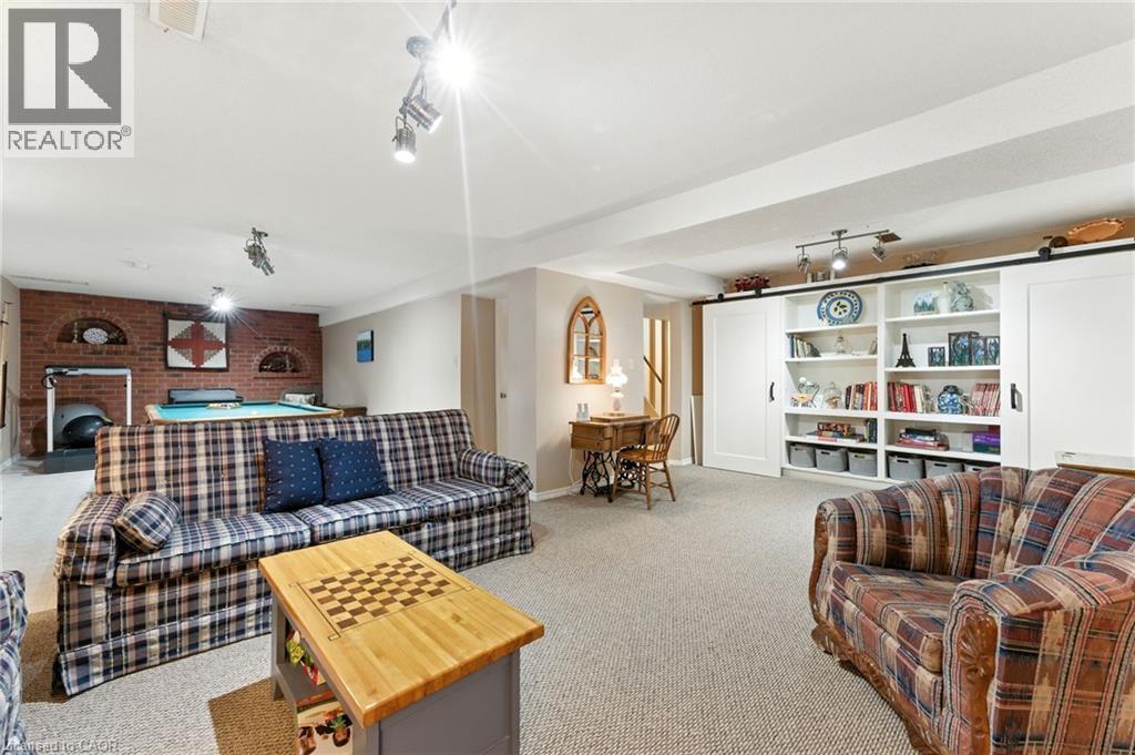 billiards, a brick fireplace, and a barn door - 3 Atkins Drive, Hamilton, ON - Indoor Photo Showing Living Room