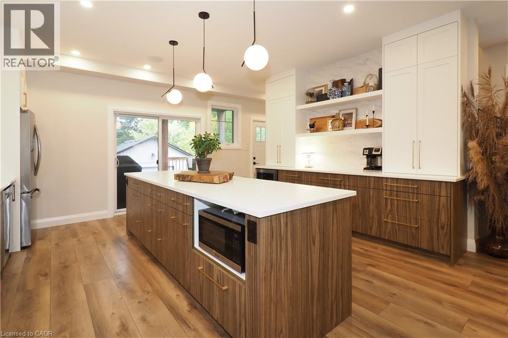 Kitchen featuring decorative light fixtures, open shelves, a kitchen island, appliances with stainless steel finishes, and recessed lighting - 238 Eagle Street S, Cambridge, ON - Indoor Photo Showing Kitchen
