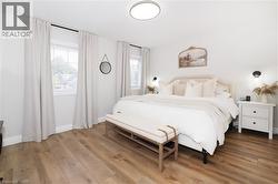 Bedroom featuring wood finished floors and baseboards -