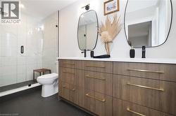 Bathroom with double vanity and a shower stall -