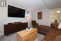 Living room featuring light colored carpet and baseboards -