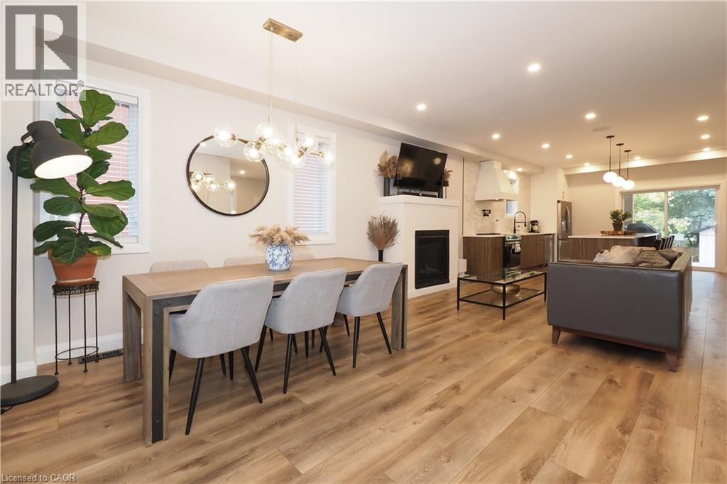Dining space featuring a fireplace, a chandelier, light wood finished floors, and recessed lighting - 238 Eagle Street S, Cambridge, ON - Indoor