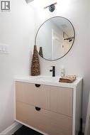 Bathroom featuring vanity and baseboards -
