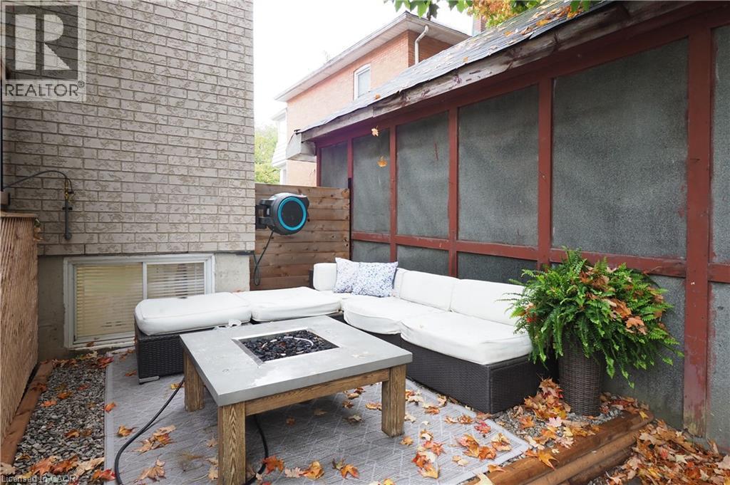 View of patio / terrace with an outdoor living space with a fire pit and a sunroom - 238 Eagle Street S, Cambridge, ON - With Exterior