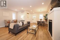 Living area featuring recessed lighting, light wood finished floors, and a fireplace -