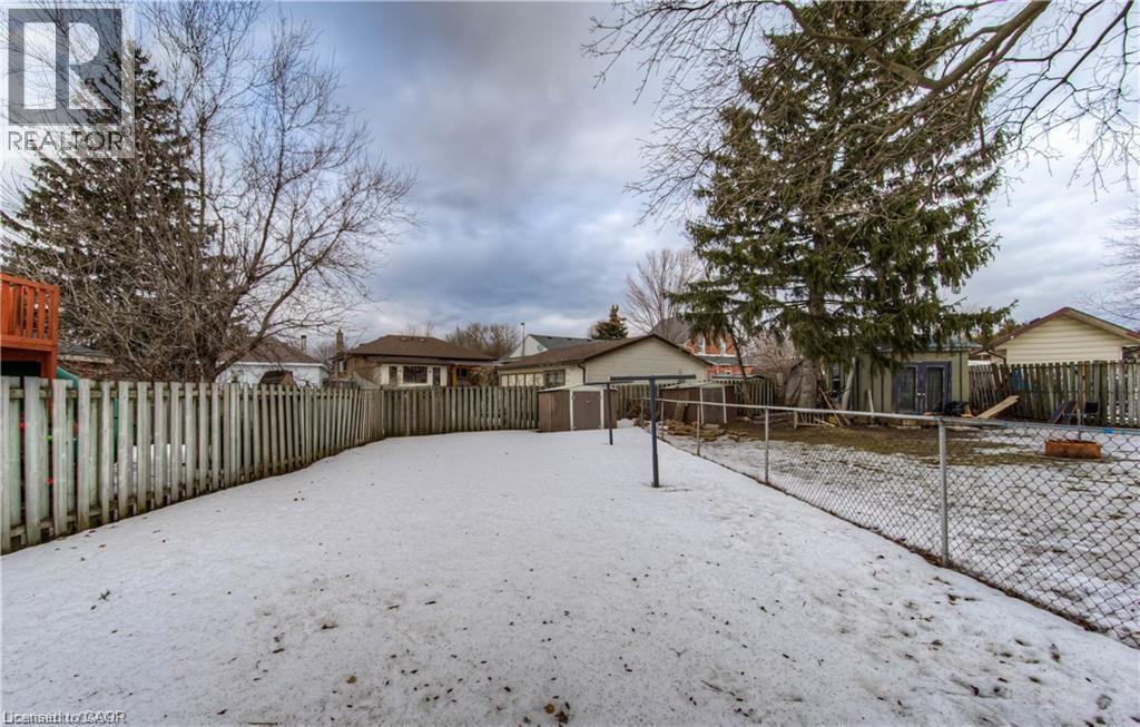 Yard covered in snow with a fenced backyard, a storage shed, and a playground - 156 Donald Street, Kitchener, ON - Outdoor