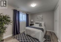 Bedroom with wood finished floors and a closet -