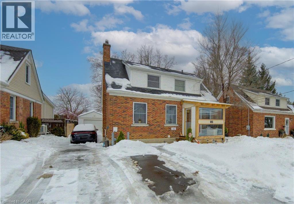 View of front of house featuring a chimney and brick siding - 569 Stirling Avenue S, Kitchener, ON - Outdoor