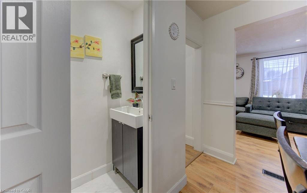 Ensuite bathroom featuring vanity and light wood-style flooring - 569 Stirling Avenue S, Kitchener, ON - Indoor Photo Showing Other Room
