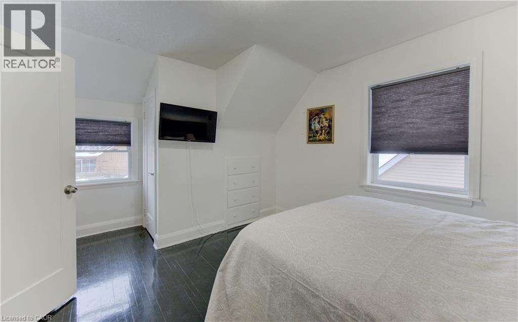 Bedroom with dark wood-style floors and lofted ceiling - 569 Stirling Avenue S, Kitchener, ON - Indoor Photo Showing Bedroom