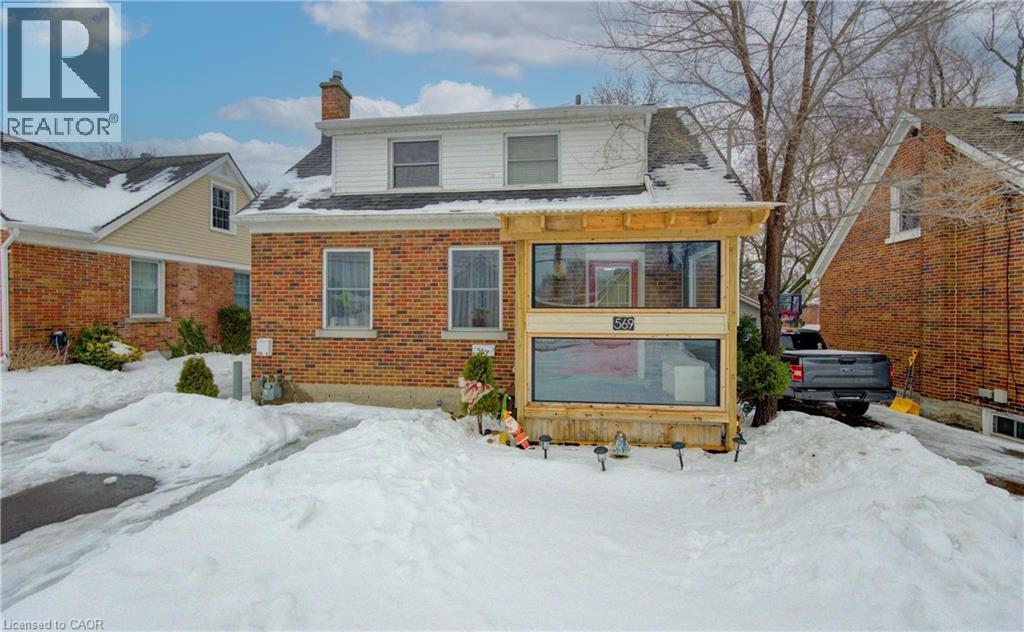 Snow covered back of property featuring a chimney and brick siding - 569 Stirling Avenue S, Kitchener, ON - Outdoor